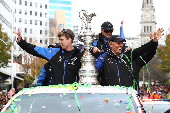 Peter Burling (L) and Grant Dalton with the America's Cup during the welcome home parade in...