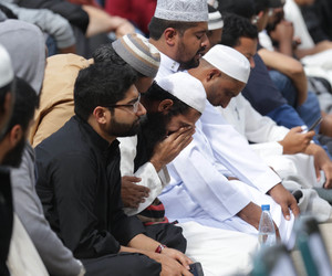 A worshipper weeps in Hagley Park ahead of today's prayer service. Photo: NZ Herald