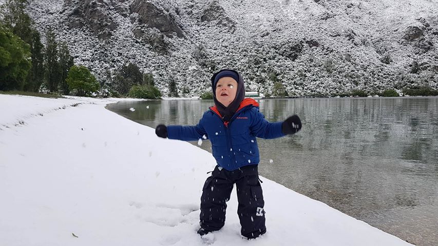 Jakob Williams (2) plays in the snow on the shores of Lake Wakatipu at Kingston this morning....