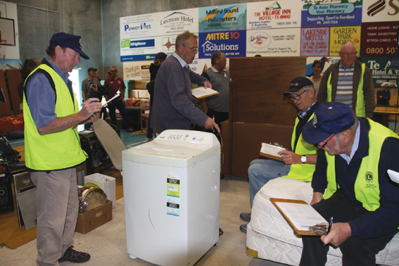 Te Anau Lions Club members from left Sandy Tee, John Hayman and Bruce Campbell assisting longtime...