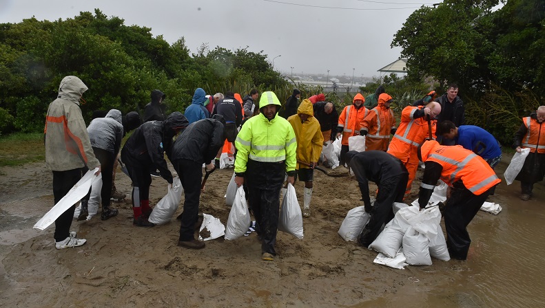 Volunteers help fill sandbags at the St Clair Tennis Club  in Victoria Rd. Photos Gregor...