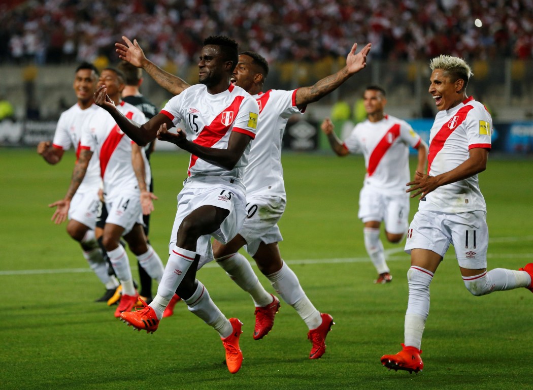 Peru's Christian Ramos (15) celebrates with teammates after scoring his side's second goal. Photo...