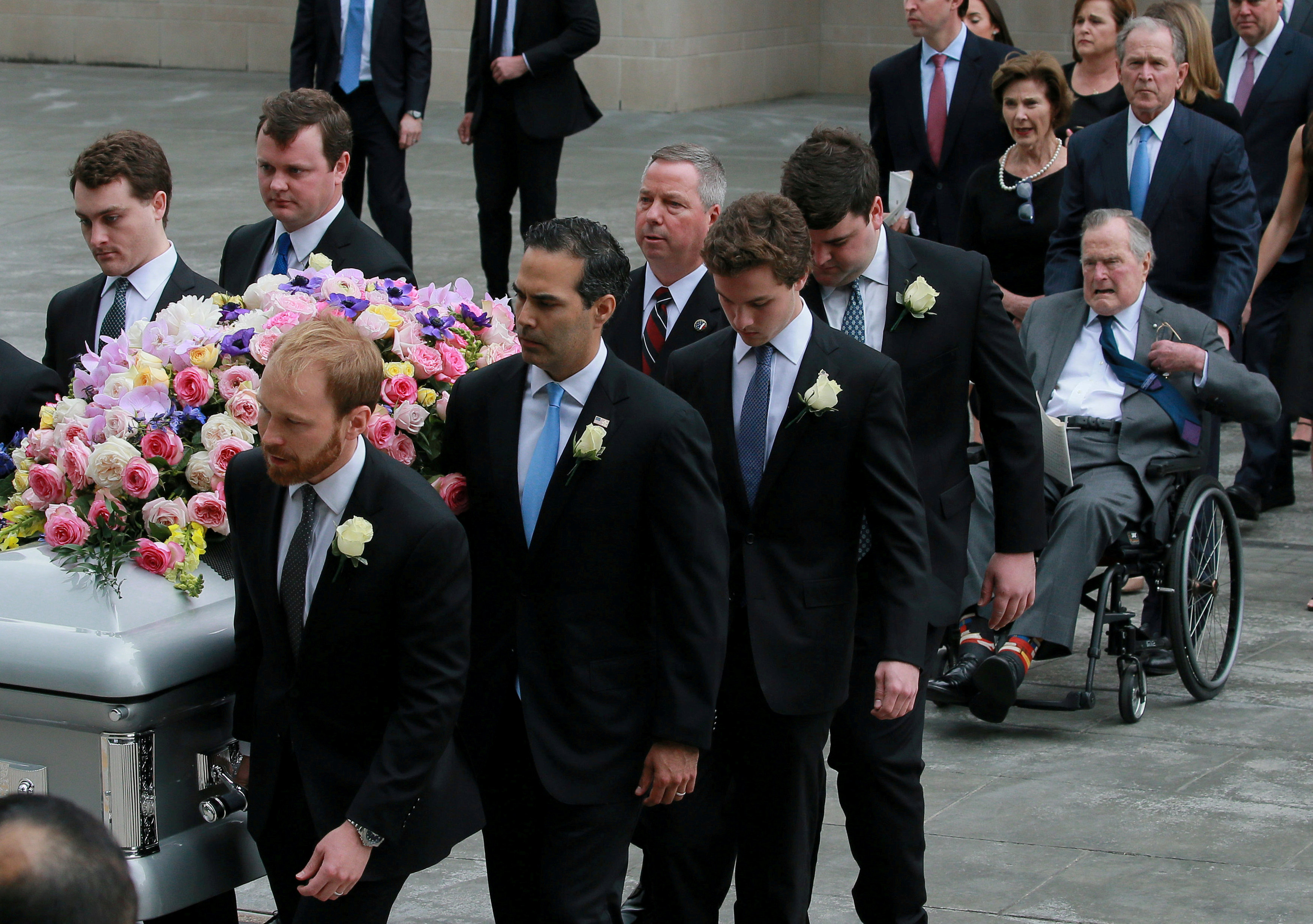 Former President George H.W. Bush (in wheelchair) attends the funeral service for his wife...