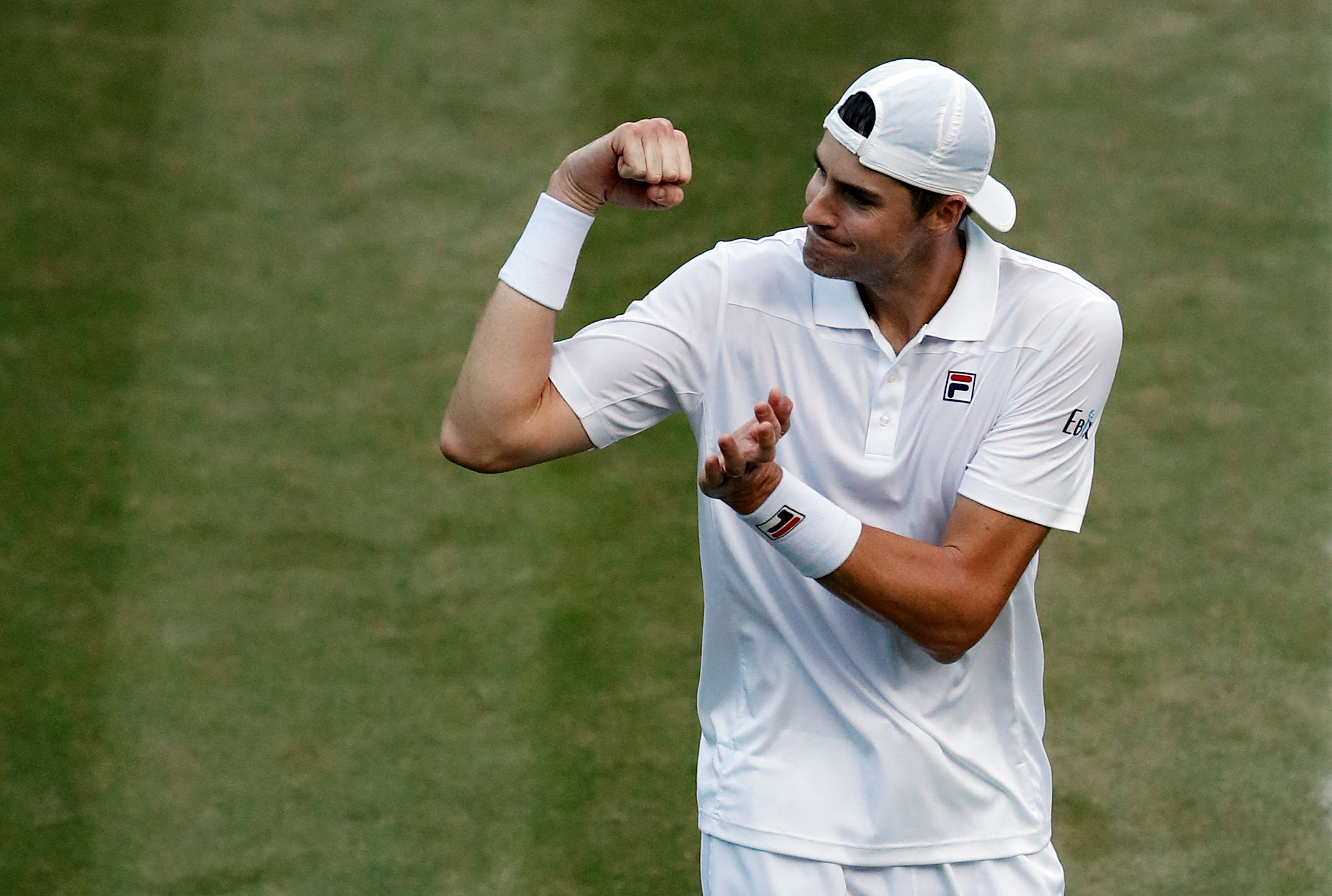 John Isner celebrates beating Milos Raonic. Photo: Reuters 