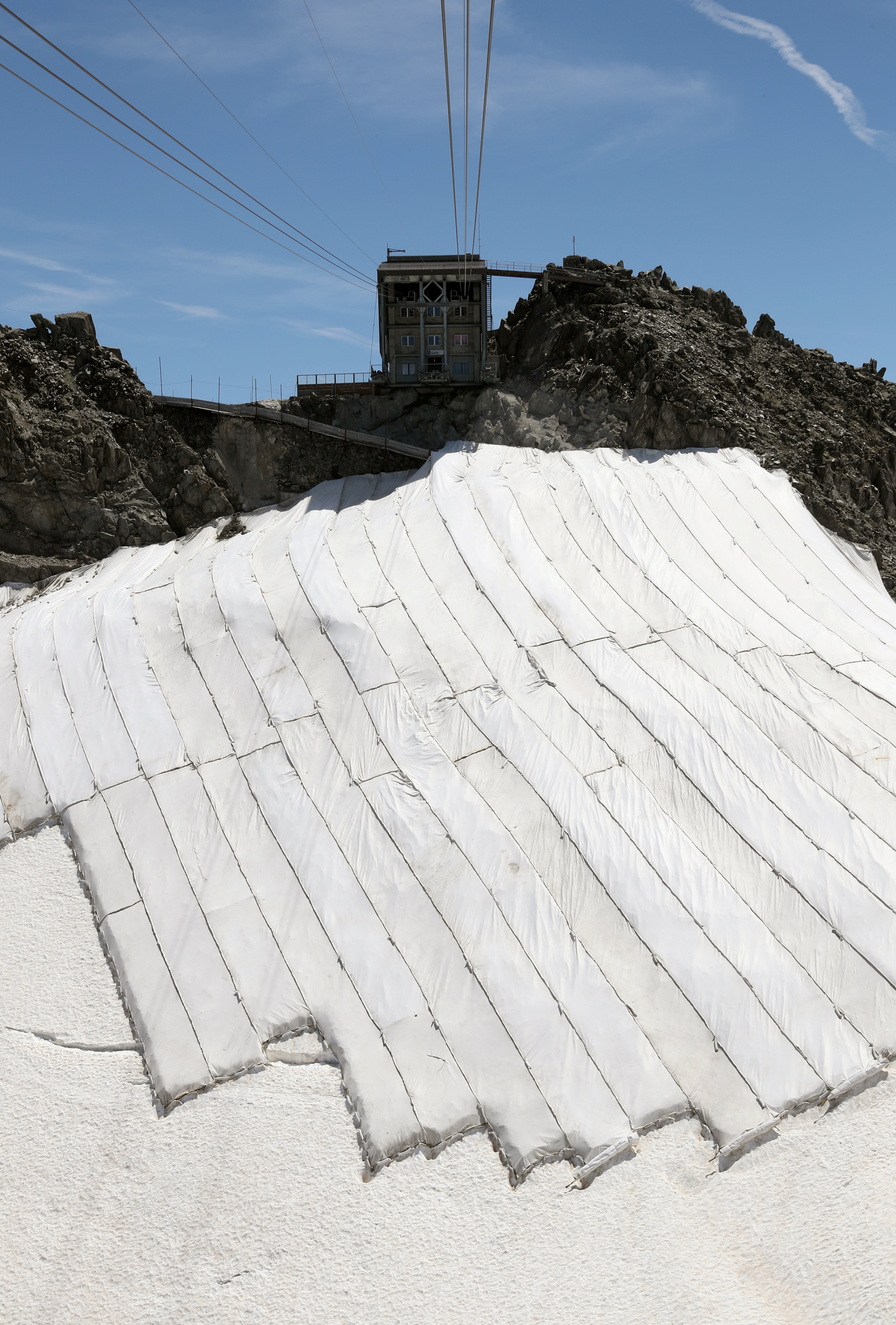 Parts of the Gurschengletscher glacier covered with tarps to help reduce melting in Andermatt...