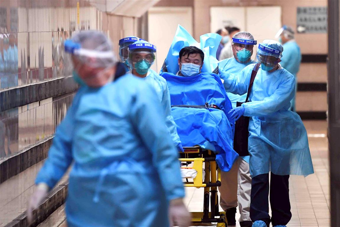 Medical staff transfer a suspected coronavirus patient at Queen Elizabeth Hospital in Hong Kong....