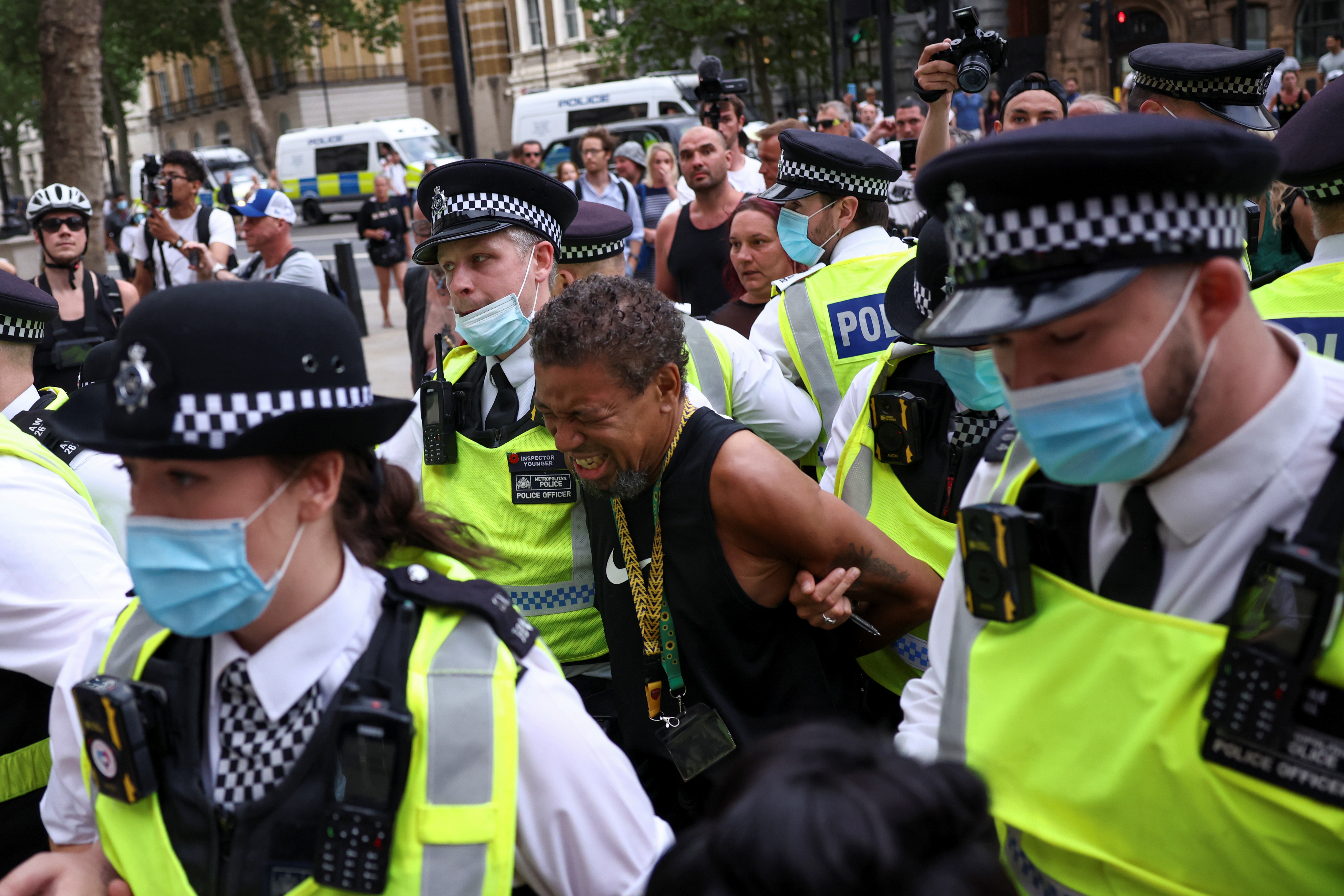 Police apprehend a demonstrator during an anti-lockdown and anti-vaccine protest in London on...