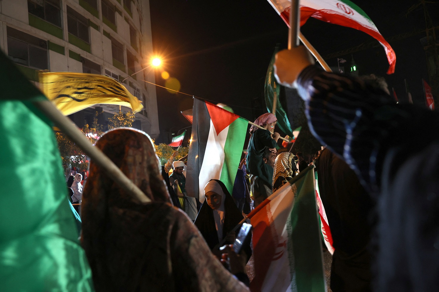 People in Tehran celebrate following Iran's attack on the US military base in Qatar. Photo: Majid...