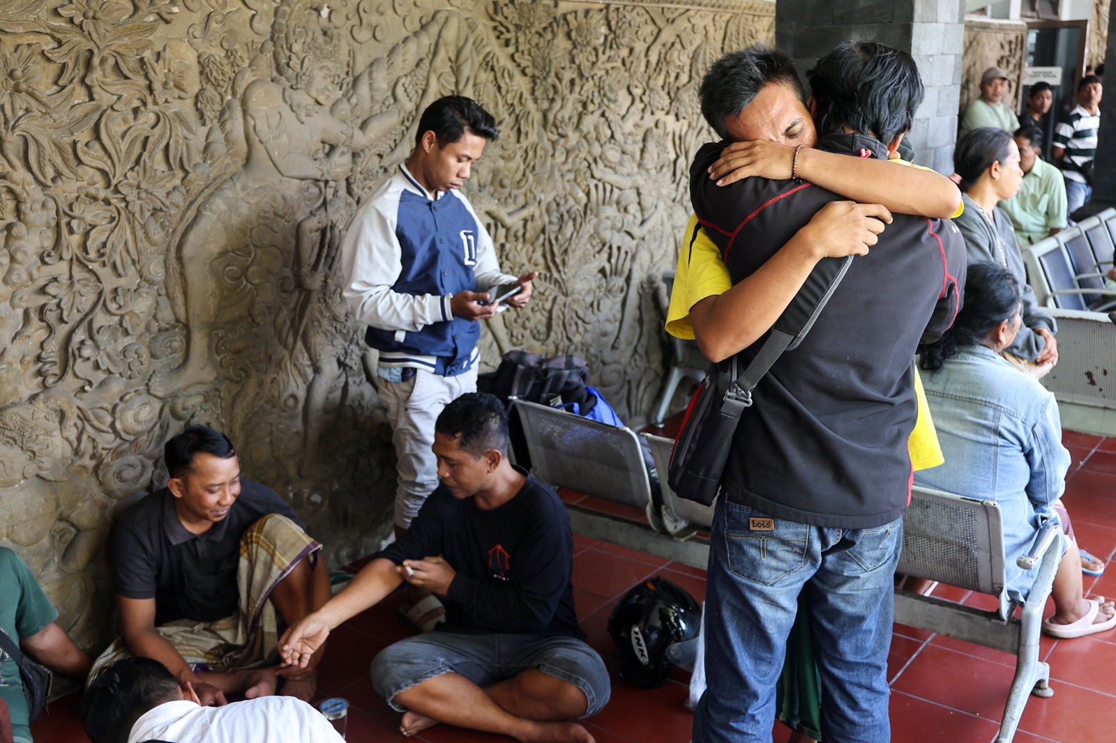 A survivor of the ferry sinking reacts as he meets a relative after making it back to land. Photo...