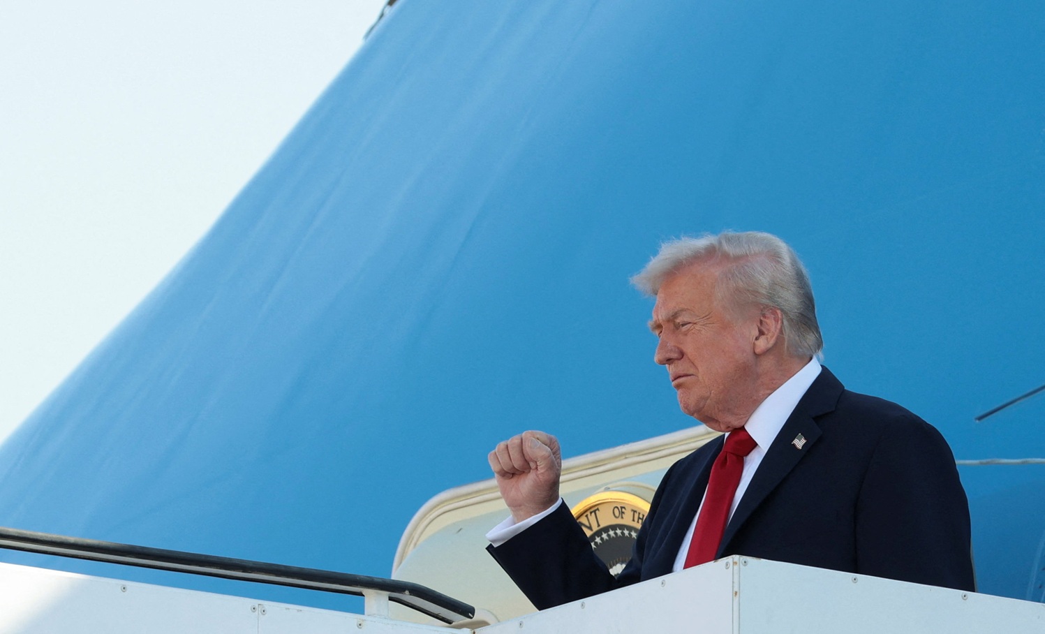 US President Donald Trump gestures as he disembarks Air Force One at Ben Gurion International...