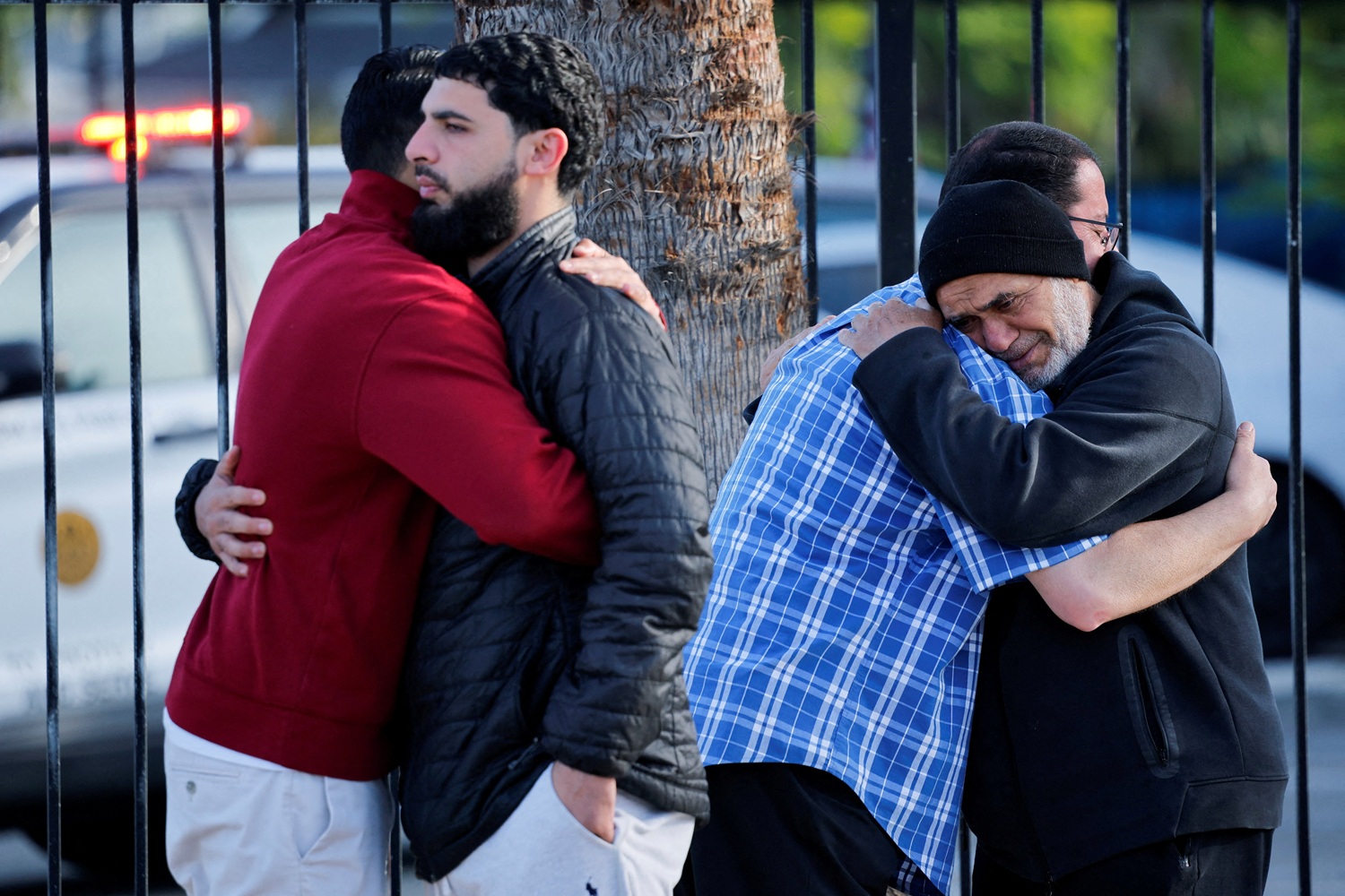 People embrace outside the Islamic Centre of San Diego, the morning after the shooting. Photo:...