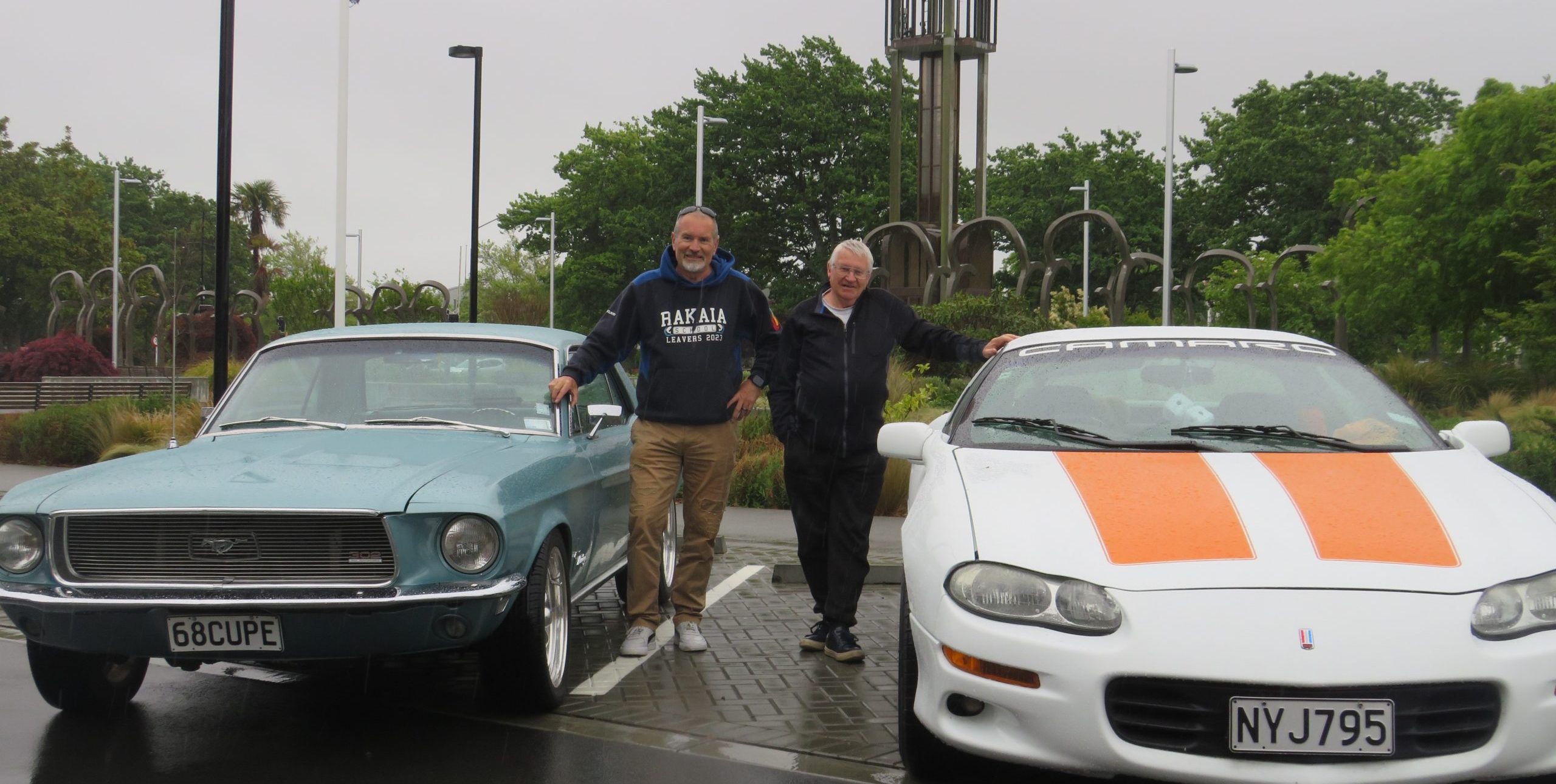 Principal Mark Ellis (left) with his 1968 Mustang and Barry Pinnell with his 1998 Camaro. PHOTO:...