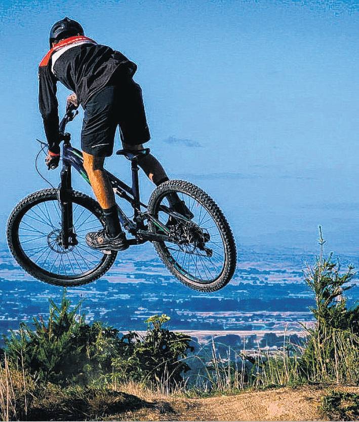 A rider enjoys one of the tracks at Arapuke Mountain Bike Park (below).