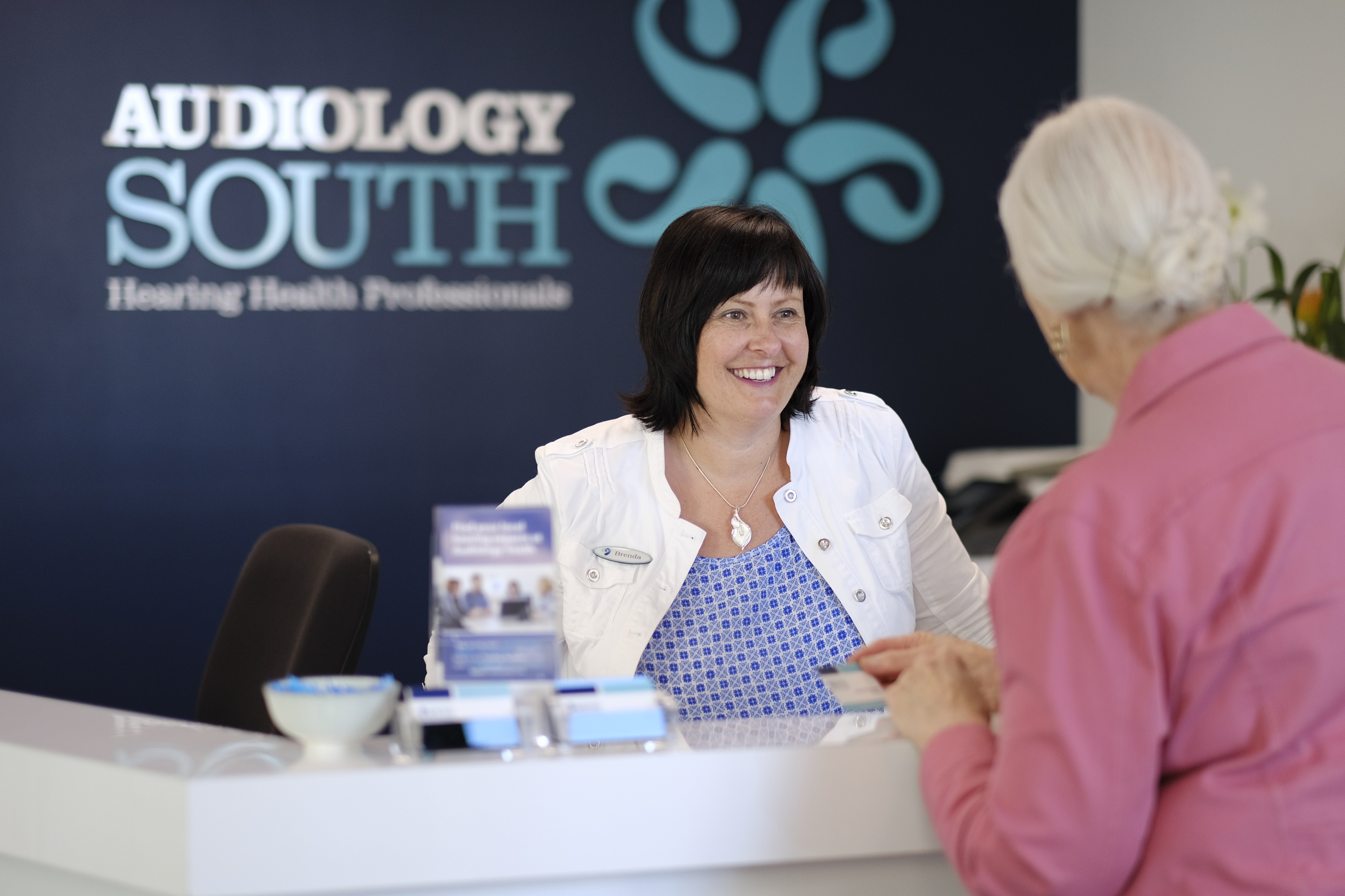 Customer Care Manager Brenda Stuart greets client Dame Lois Muir at the Dunedin clinic