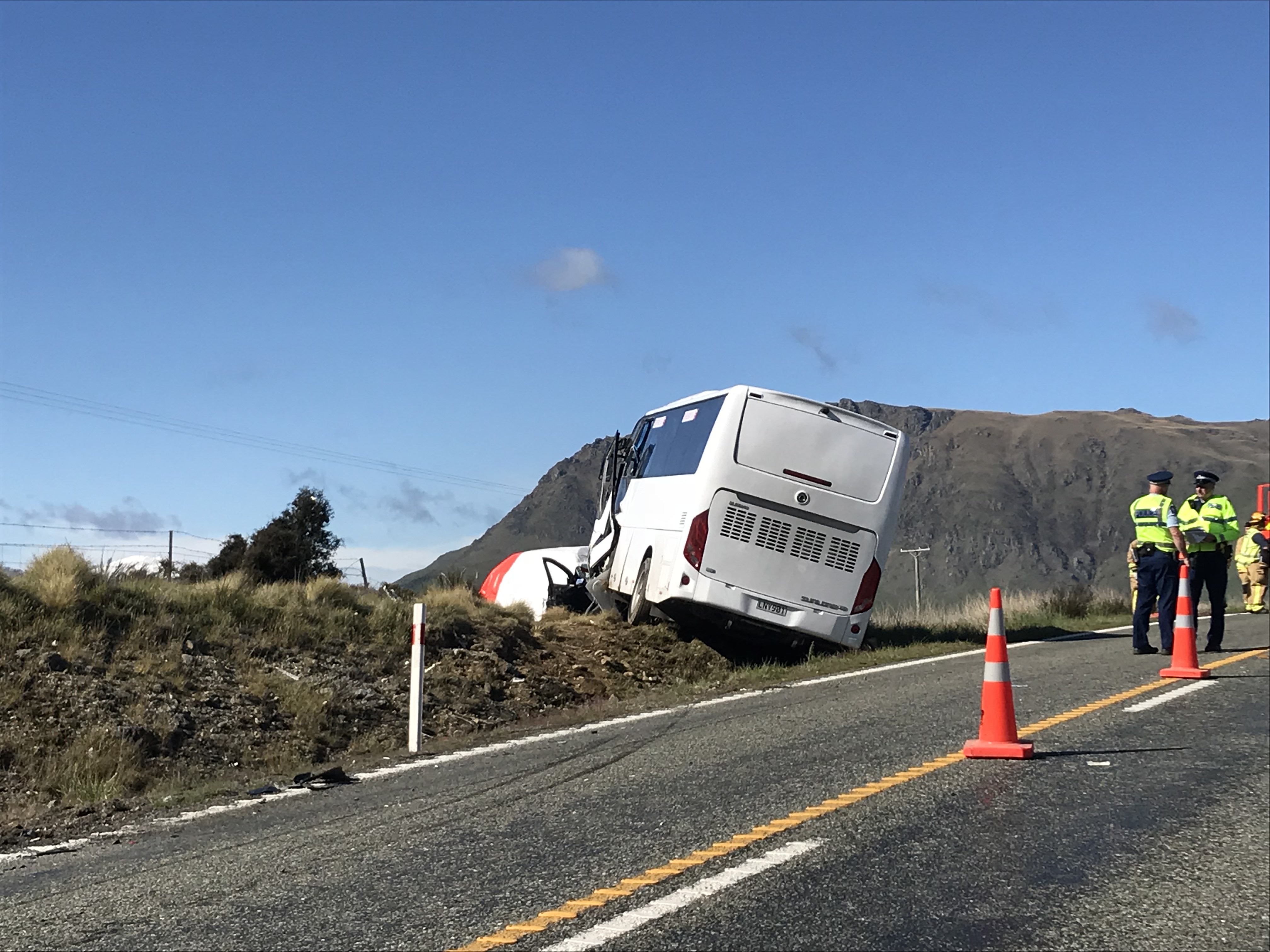 The bus, which appears to have been travelling south, is off the road, beside the south-bound...