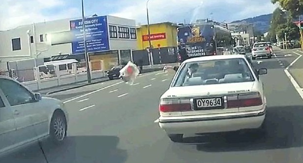 A motorist flings a bag of rubbish from a car in Crawford St in this video image captured by...