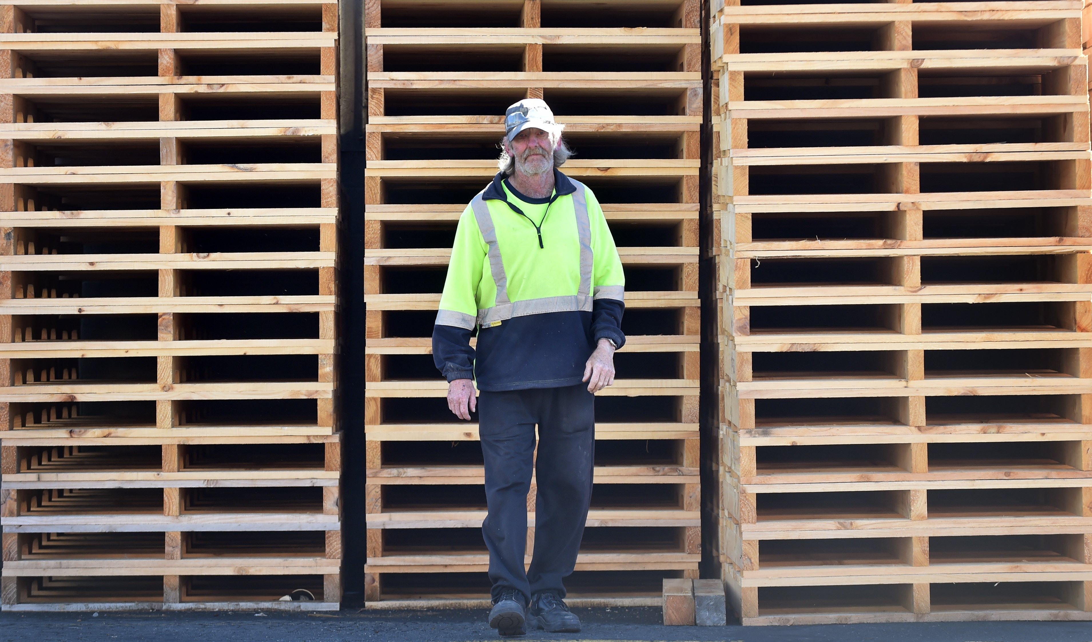 Lindsay Keane by a stack of Cargill Enterprises' pallets. PHOTO: PETER MCINTOSH