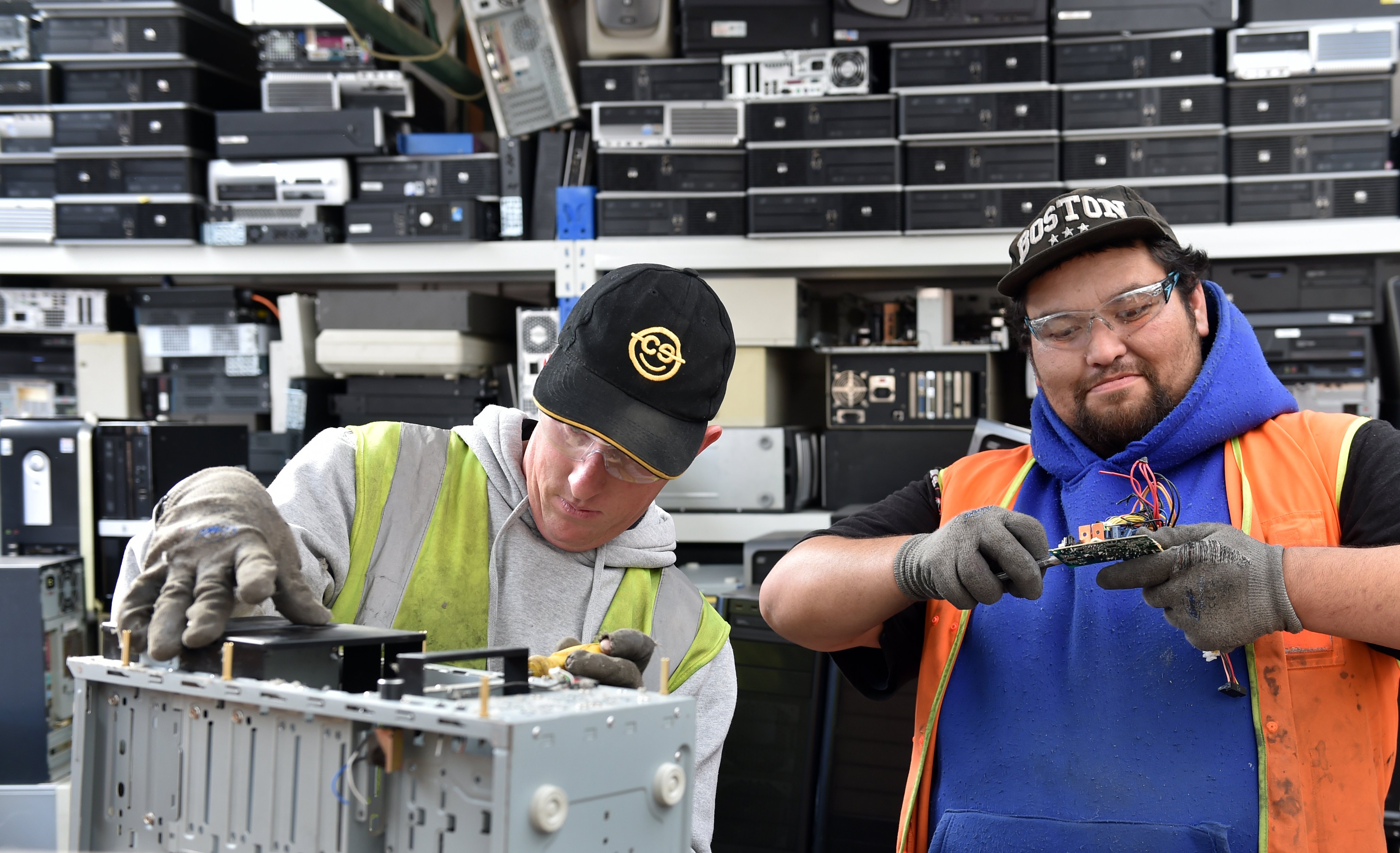 Jeremy Waldron (left) and James Wilson hard at work dismantling computer equipment. PHOTO: PETER...