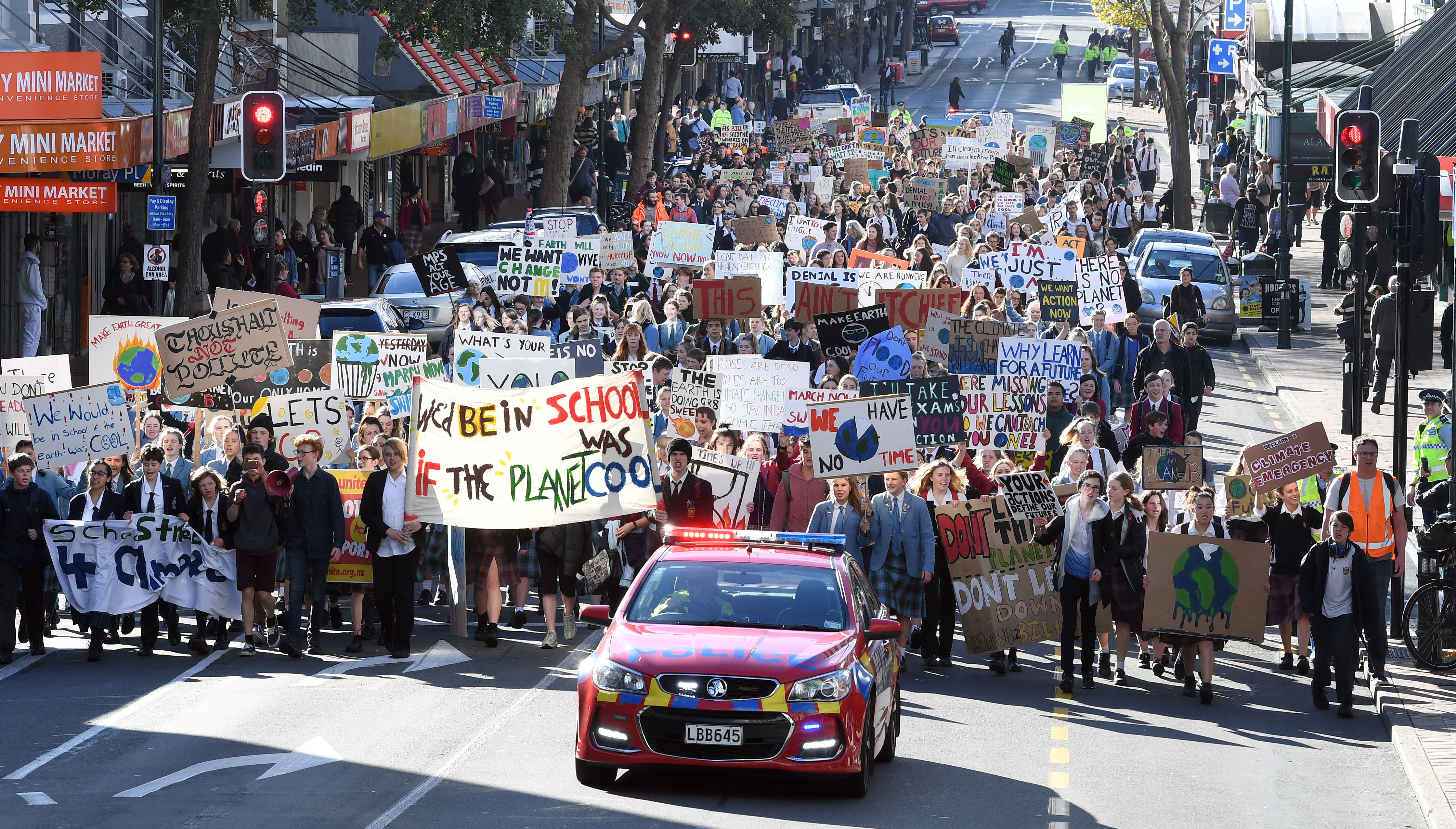 Students marching along George St towards the Octagon this afternoon. Photo: Stephen Jaquiery