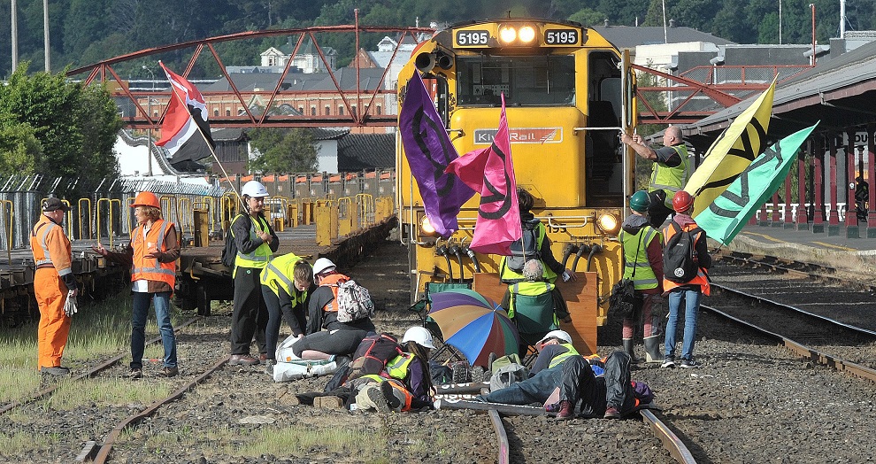 Several of the protesters have locked themselves to the train tracks at Dunedin Railway Station....