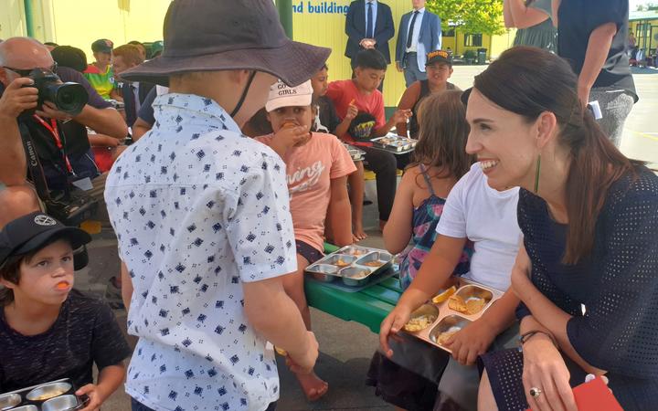 Prime Minister Jacinda Ardern talks to pupils receiving a free lunch at Flaxmere Primary School....