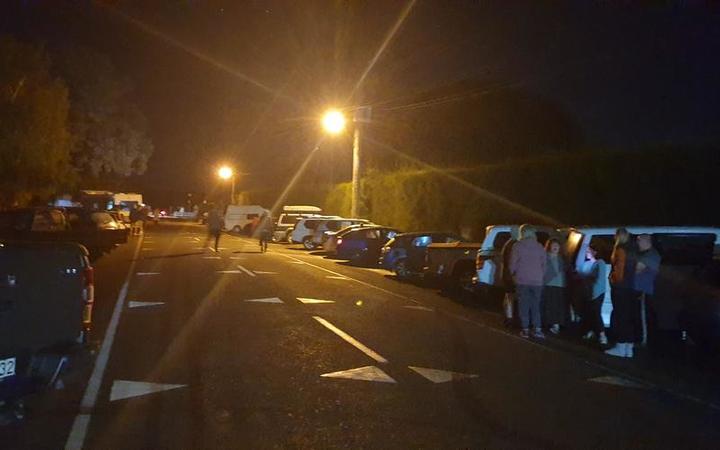 Cars line up at Haumoana School in Hawke's Bay, where people from coastal communities of Te...