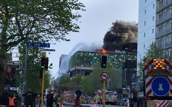 Flames and smoke were still coming from the roof of the convention centre this morning. Photo: RNZ 