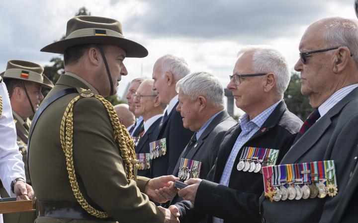 Major General Gregory Bilton presents members of 161 Battery, 16th field regiment with their...