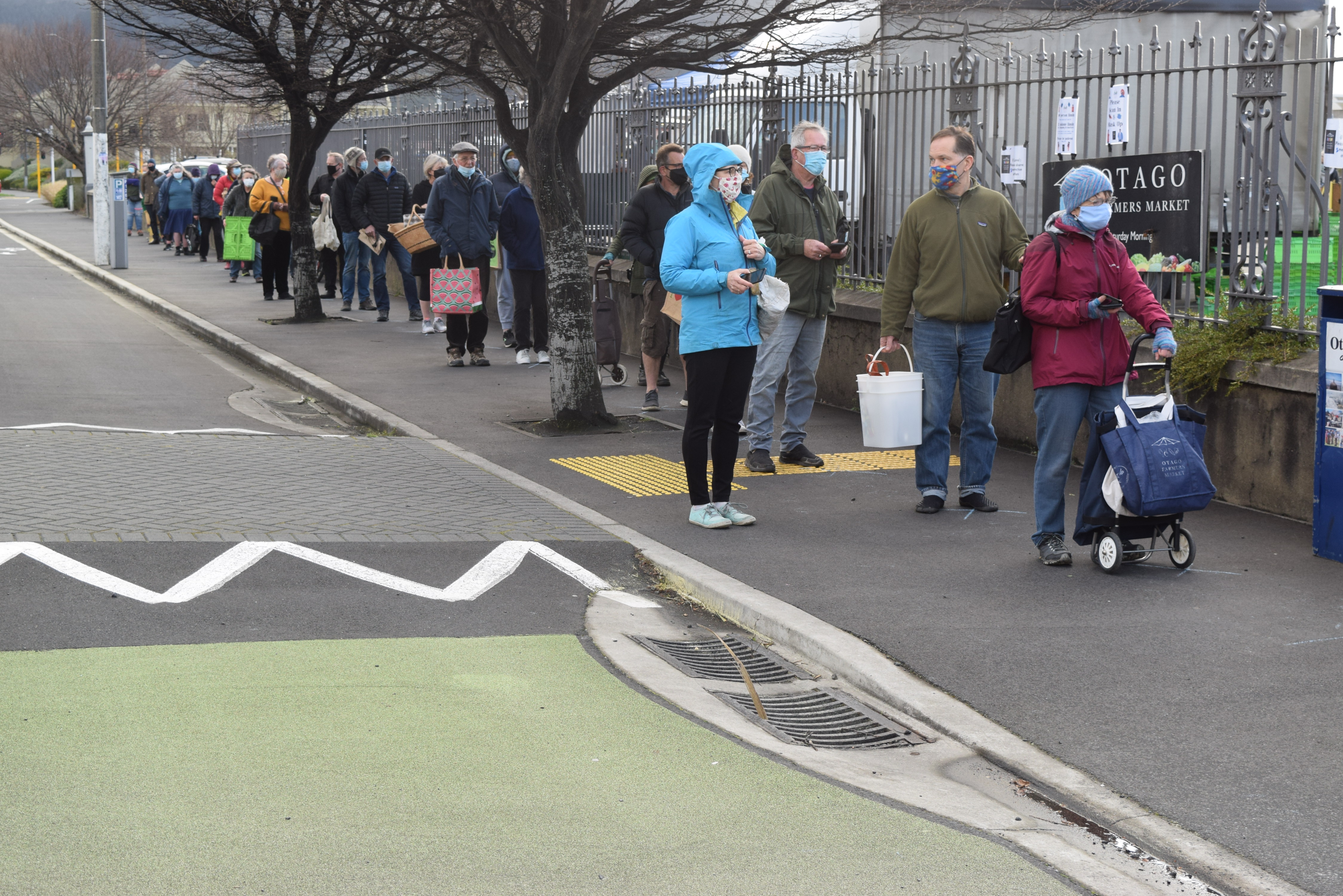 Shoppers queue to enter Otago Farmers Market in Dunedin this morning. PHOTO: SHAWN MCAVINUE