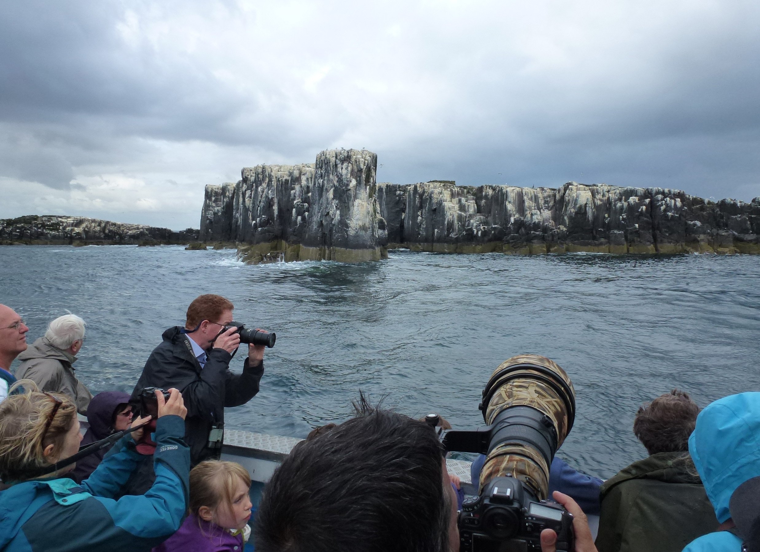 Lenses line up wildlife as a tour boat skirts one of the outer islands of the Farne group. PHOTO: NEVILLE PEAT