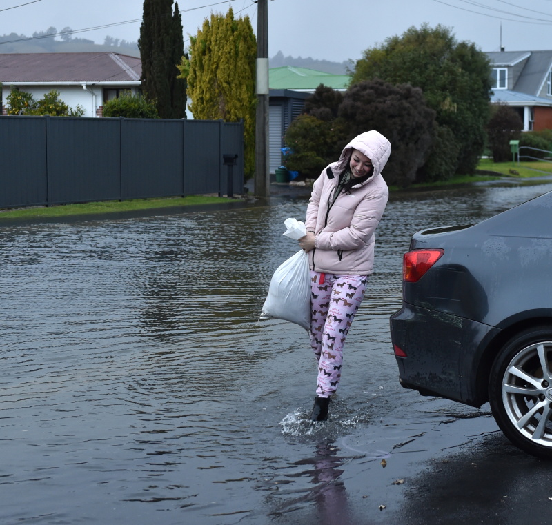 Natalia Hannigan drops off sand bags for her father-in-law following heavy rain in Dunedin,...