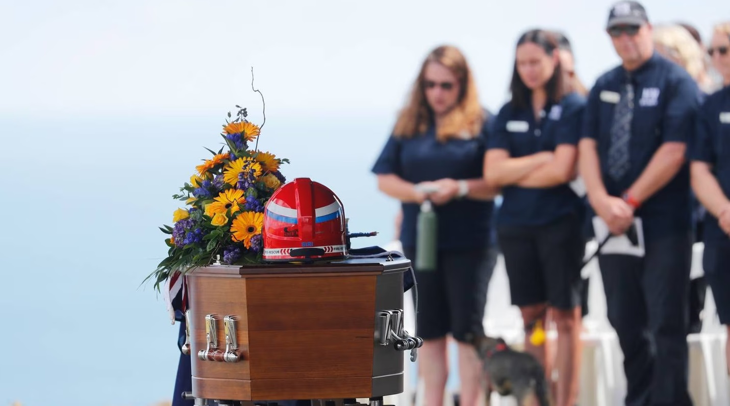 A New Zealand flag was draped across David van Zwanenberg's casket which was adorned with flowers...