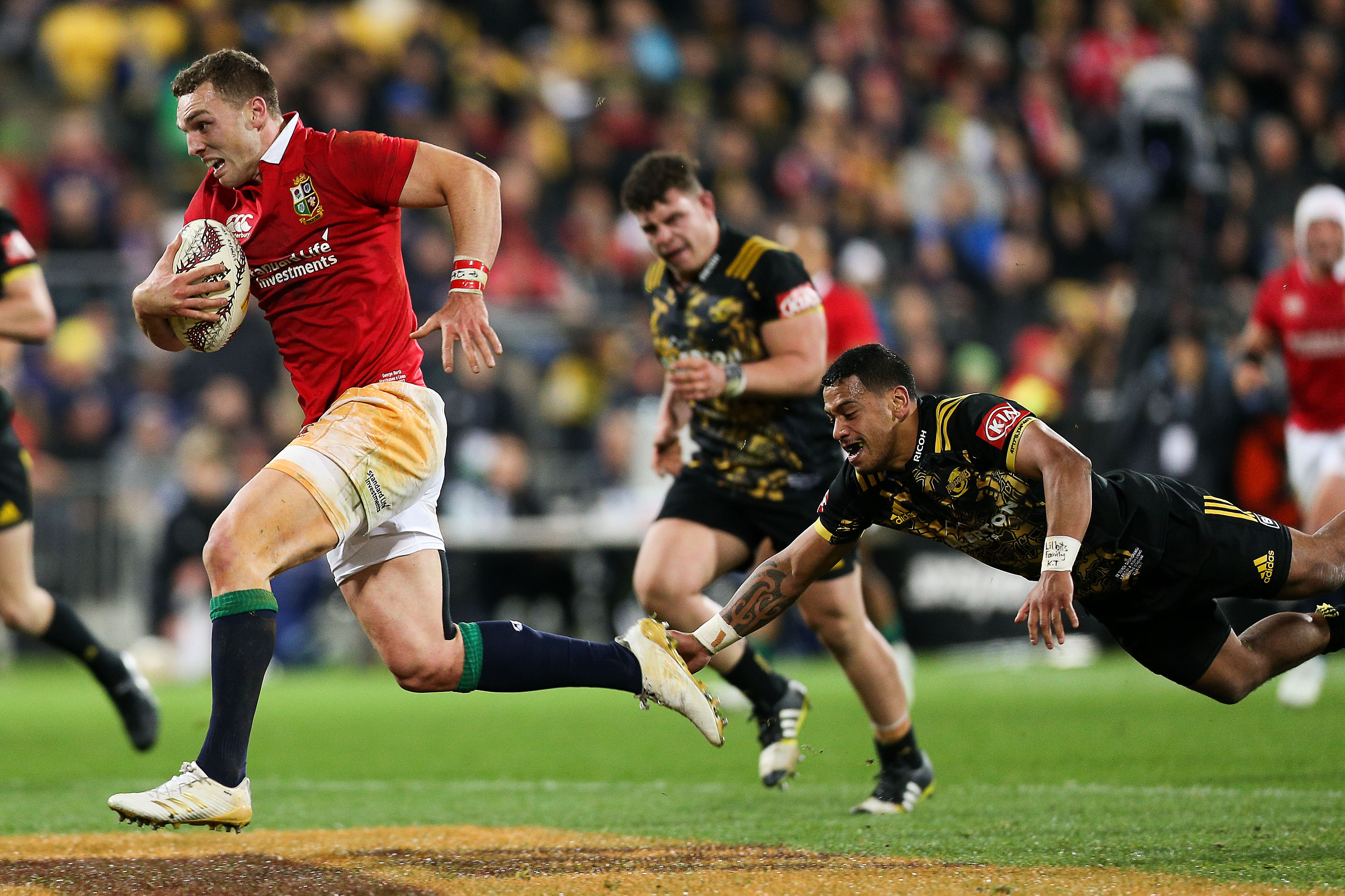 George North of the Lions beats the tackle of Te Toiroa Tahuriorangi of the Hurricanes to break...