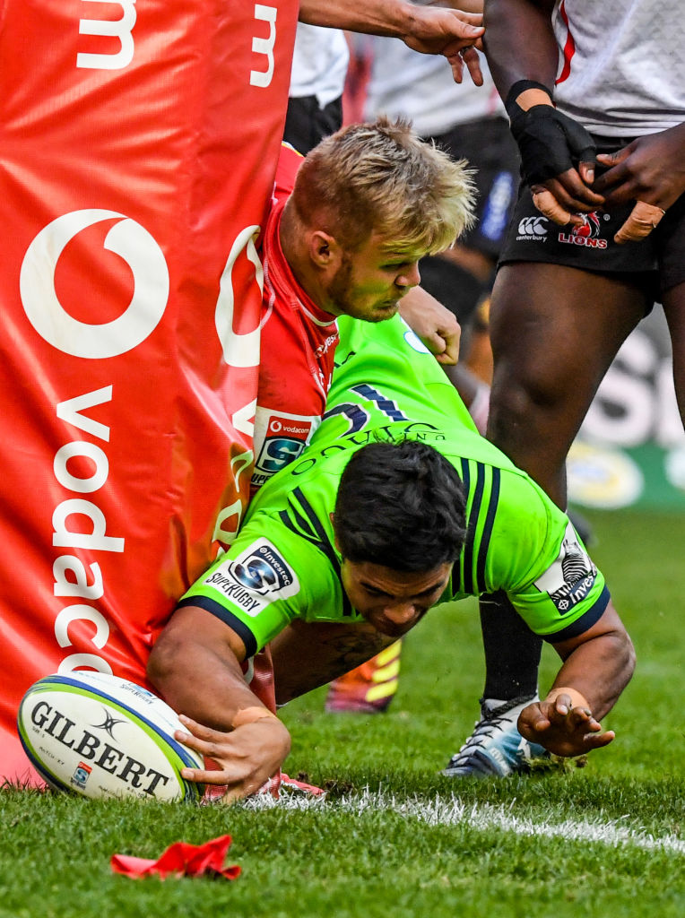 Josh Ioane inches around the post to score a try for the Highlanders at Ellis Park. Photo: Getty...