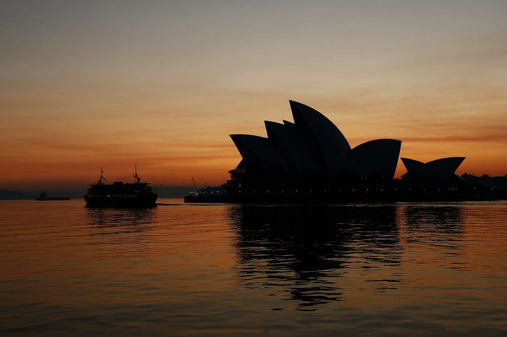 A smoky sunrise behind the Sydney Opera House on Tuesday morning. Photo: Getty