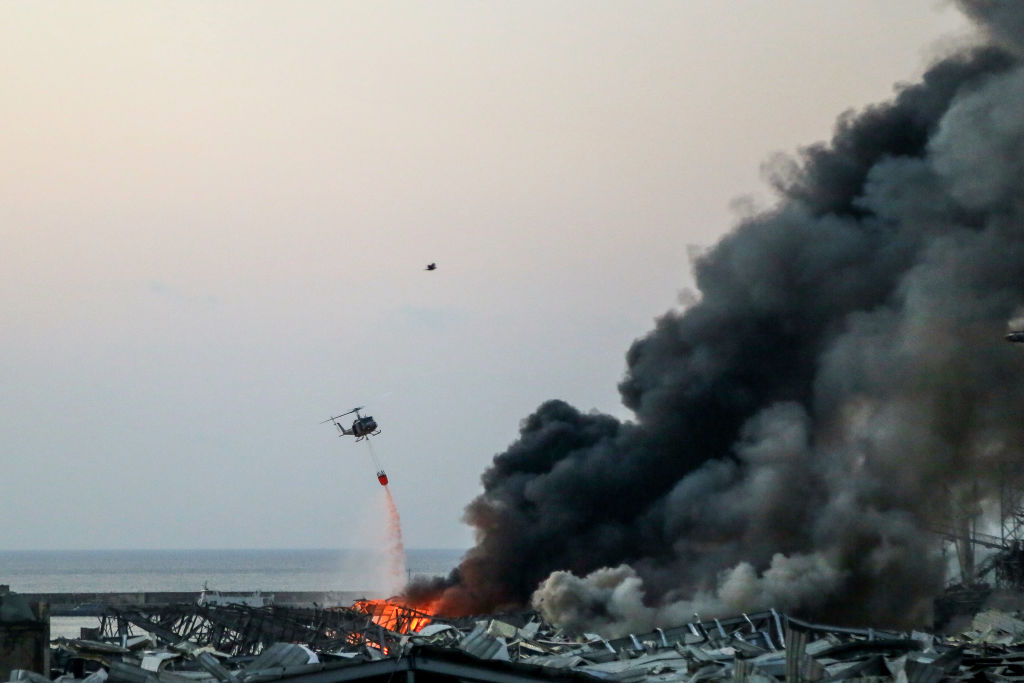 A military helicopter fights the fire following the explosion in Beirut's port. Photo: Getty Images