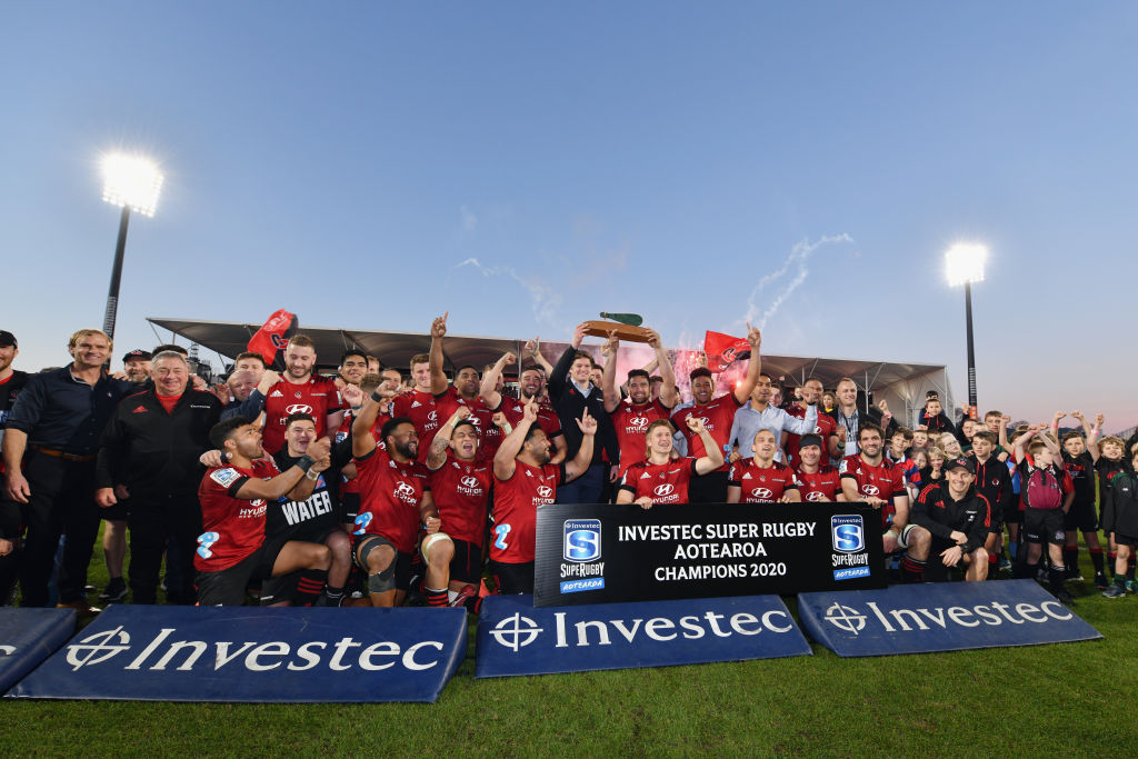 The Crusaders celebrate with the Super Rugby Aotearoa trophy after their win over the Highlanders...