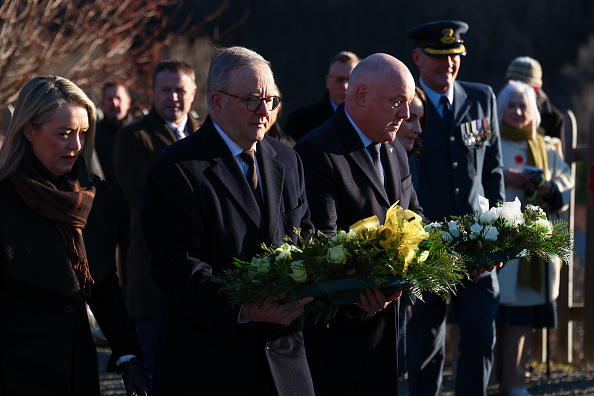 Anthony Albanese (left) and Christopher Luxon carry laid wreaths at Arrowtown War Memorial Park...