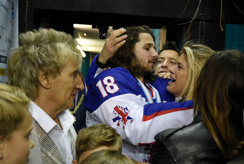 Rachel Hunter hugs her son son Liam Stewart as ex-husband Rod Stewart stands by after Liam won...