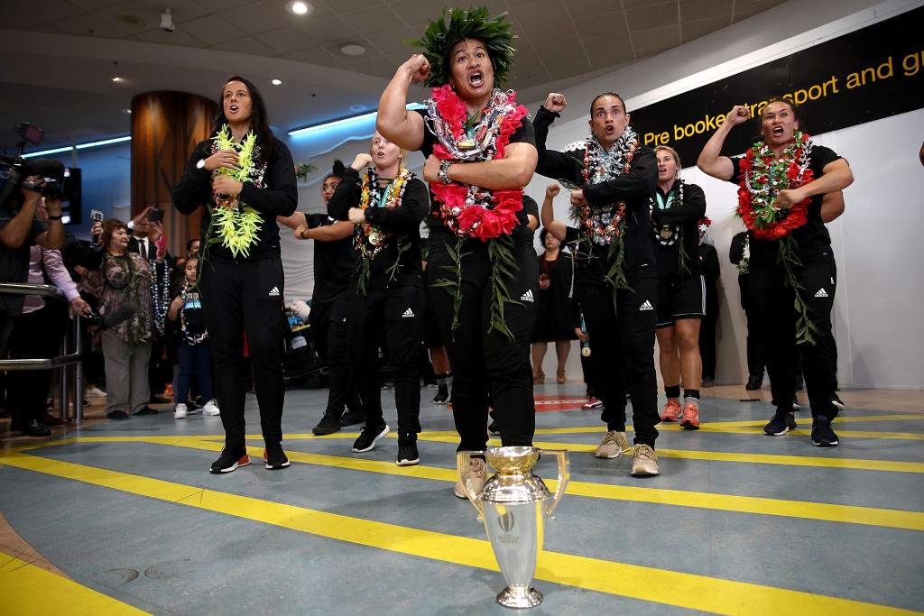The World Cup-winning Black Ferns perform a haka behind the trophy after arriving at Auckland...