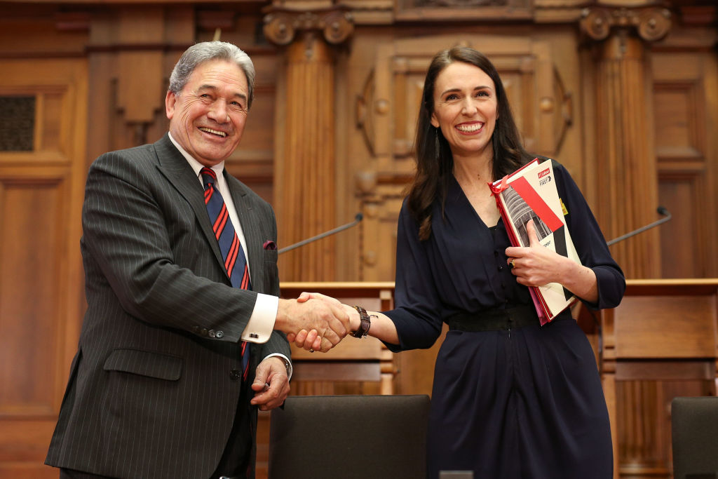 Labour leader Jacinda Ardern and NZ First leader Winston Peters shake hands during a coalition...