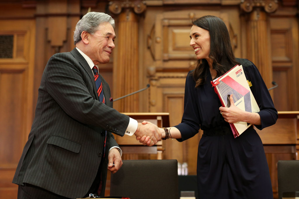 Labour leader Jacinda Ardern and NZ First leader Winston Peters shake hands during a coalition...