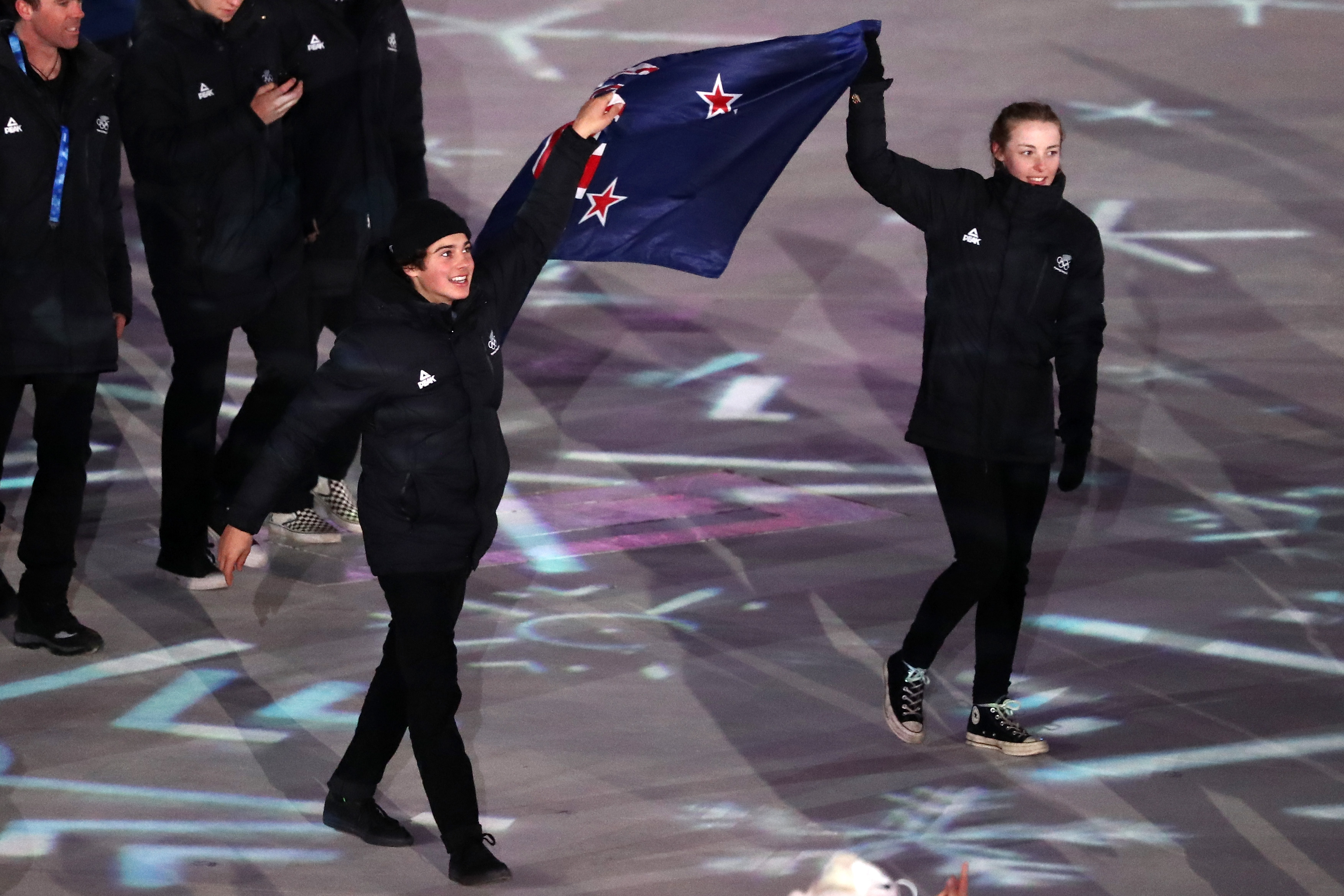 Bronze medallists Nico Porteous (left) and Zoi Sadowski-Synnott carried the flag in the Parade of...