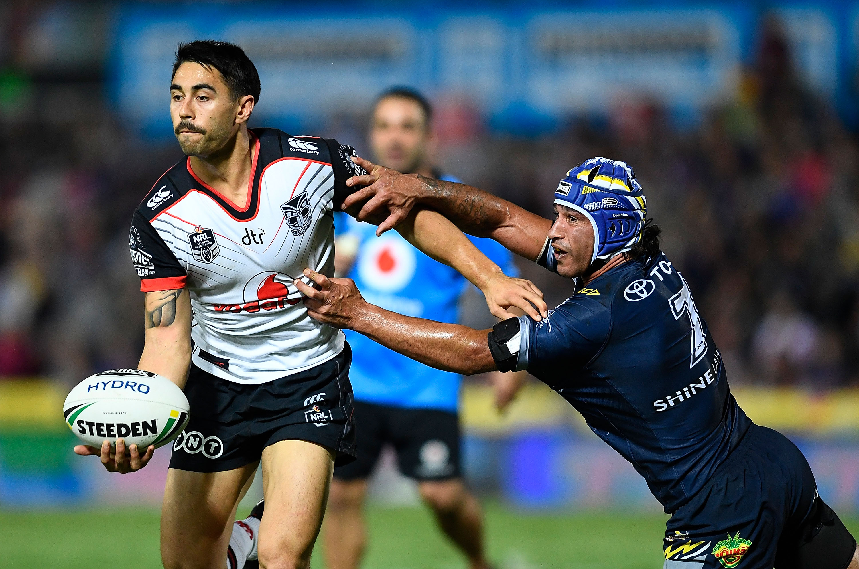 Shaun Johnson, of the New Zealand Warriors, looks to get a pass away despite the tackle of...