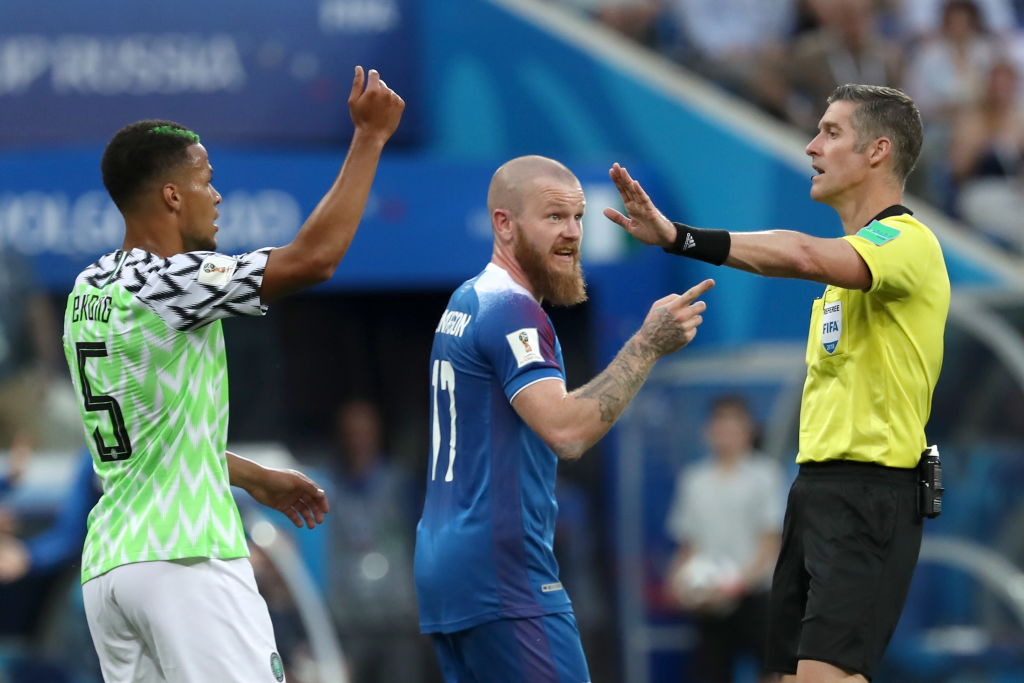 Nigeria's William Troost-Ekong and Iceland's Aron Gunnarsson talk to referee Matthew Conger...