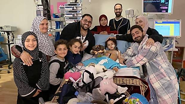 Mosque shooting survivor Alen Alsati is surrounded by family and friends in Starship hospital...