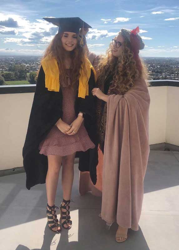 Katie Hollings with Lucy Southwell in their homemade graduation get-up. 