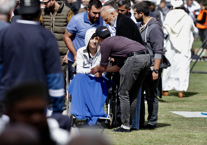 Zaid Mustafa (14) greets worshippers at prayers in Hagley Park. Photo: NZ Herald