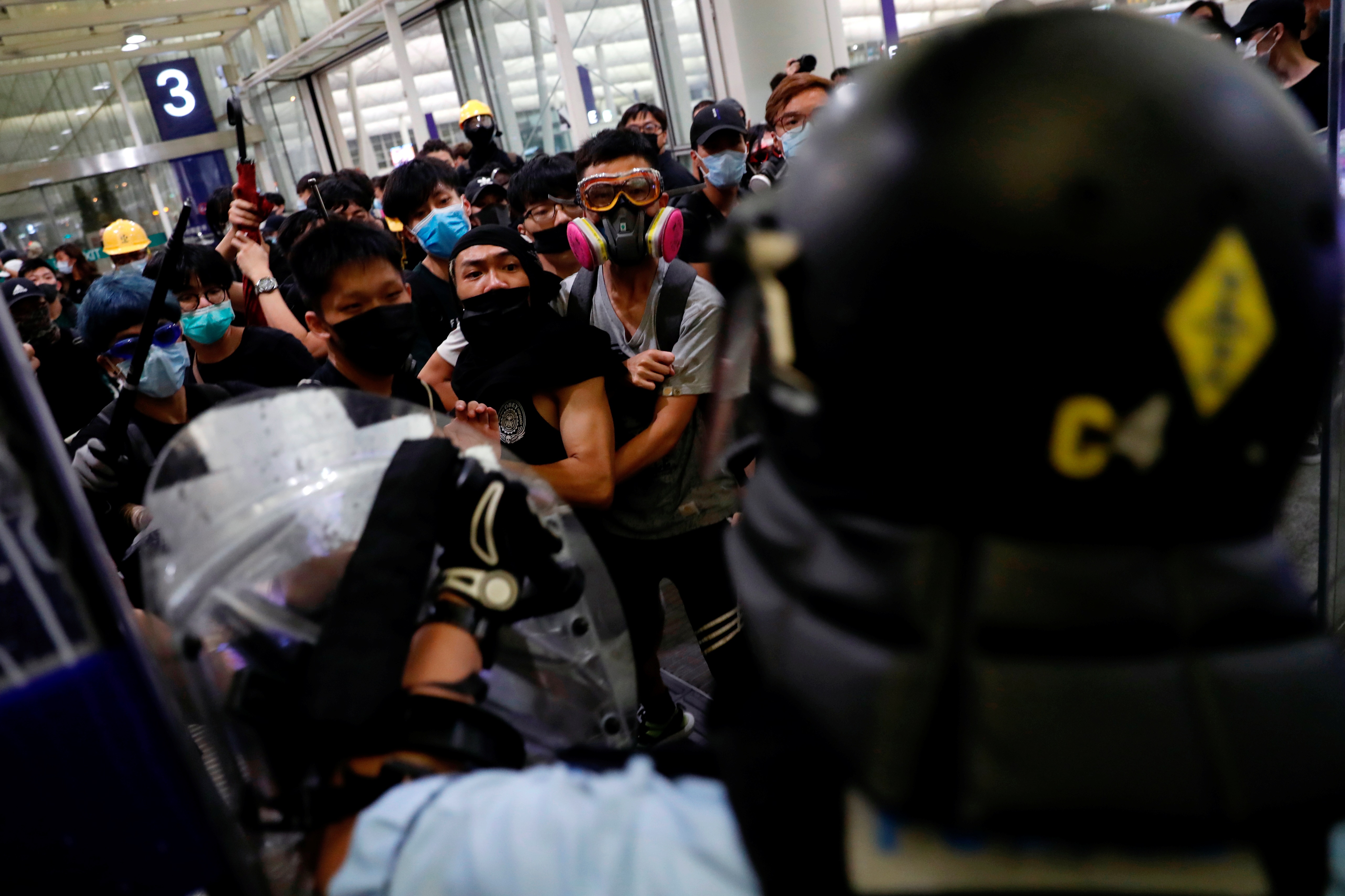 Anti-extradition bill protesters face riot police during a mass demonstration at the Hong Kong...