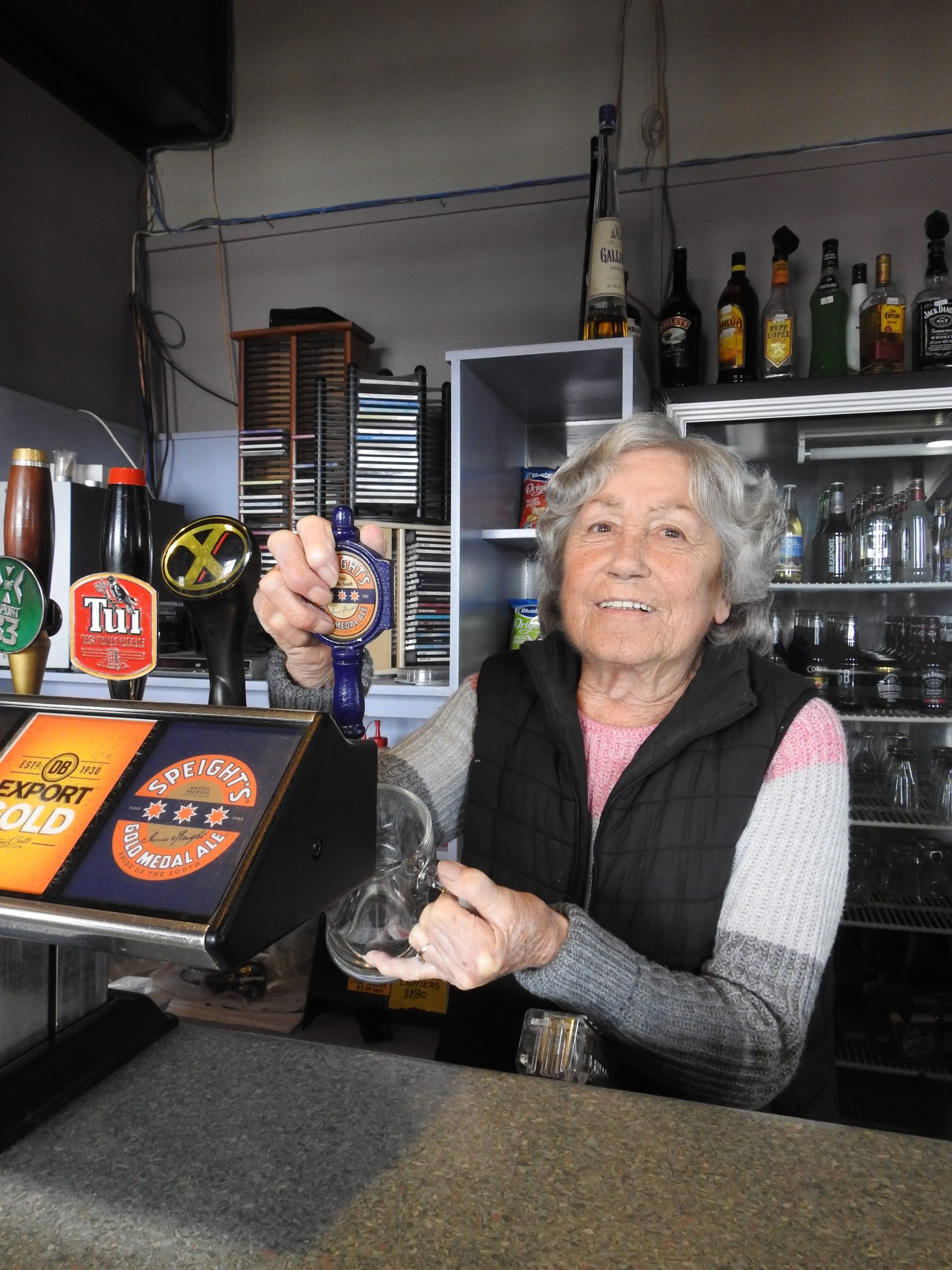 Mavis Barton pulls one of her last handles in the Amberley Hotel. Photo: North Canterbury News